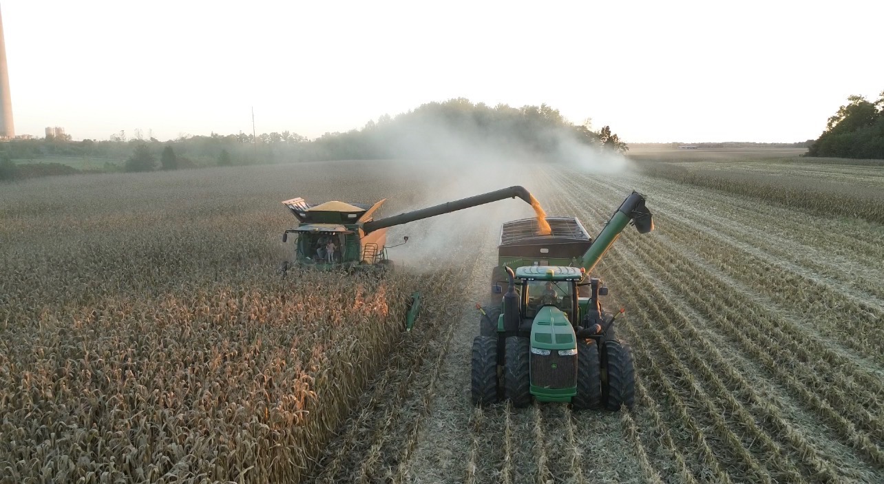 combine and wagon in field